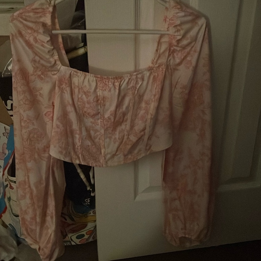 A floral crop top and it is corset like in the front brand new ,good quality